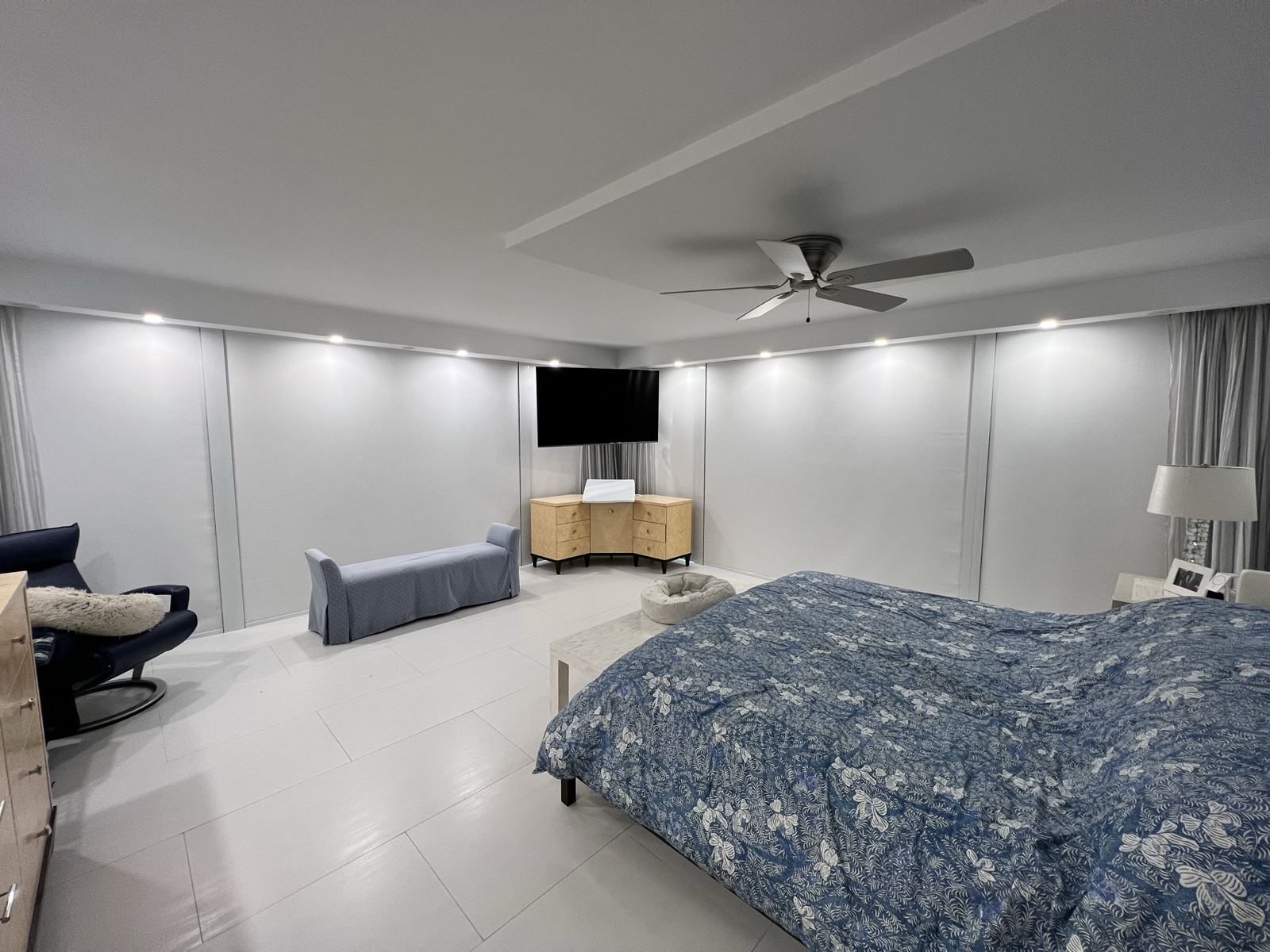 The same bedroom with the shades lowered across the glass walls