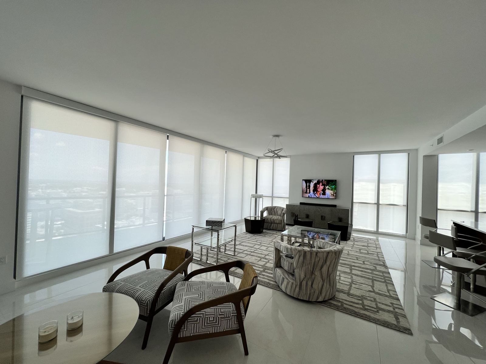 The same living room with roller shades lowered